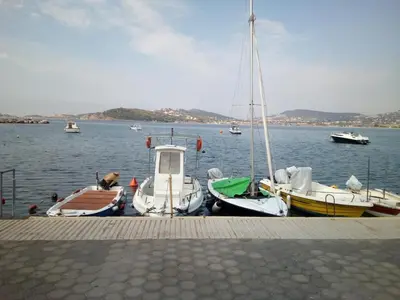 a group of boats docked in a body of water at Family and friendly home. in Palaiá Fókaia