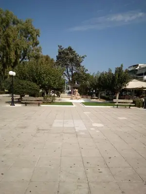 a park with two benches and a street light at Family and friendly home. in Palaiá Fókaia
