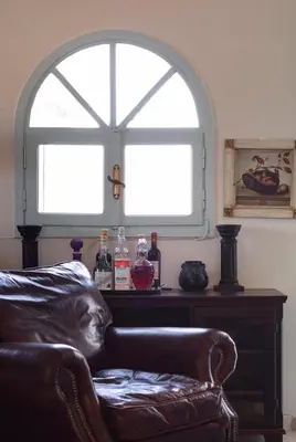 a living room with a couch and a window at Family and friendly home. in Palaiá Fókaia