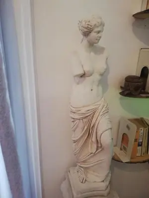a statue of a woman standing on a pedestal at Athens Riviera apt with seaview, 15' to Acropolis in Athens