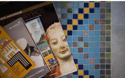 a group of magazines on a tiled wall at A litte Taste of Home Guest House in Athens