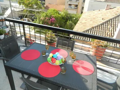 a table with a bowl of candy on a balcony at So Athens - Charming 1BD flat, Large terrace, Acropolis view in Athens