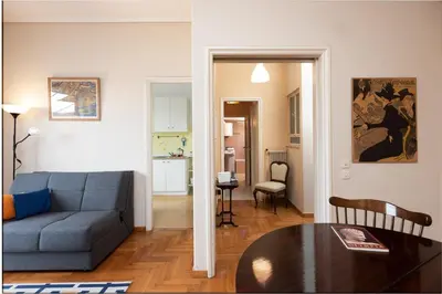a living room with a couch and a table at So Athens - Charming 1BD flat, Large terrace, Acropolis view in Athens