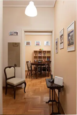 a living room with a table and chairs and a chair at So Athens - Charming 1BD flat, Large terrace, Acropolis view in Athens