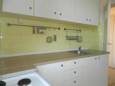 a kitchen with white cabinets and a sink at So Athens - Charming 1BD flat, Large terrace, Acropolis view in Athens