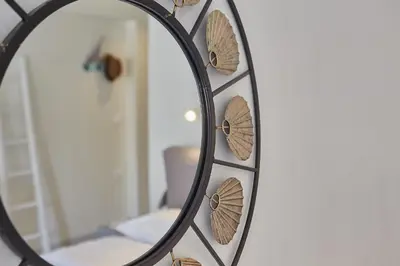 a mirror with wooden circles on a wall at toStay-Unique apartment hotel in Athens center! in Athens