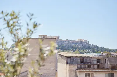 a view of a building with a hill in the background at toStay-Unique apartment hotel in Athens center! in Athens