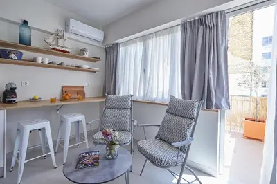 a kitchen with two chairs and a table and a window at toStay-Unique apartment hotel in Athens center! in Athens