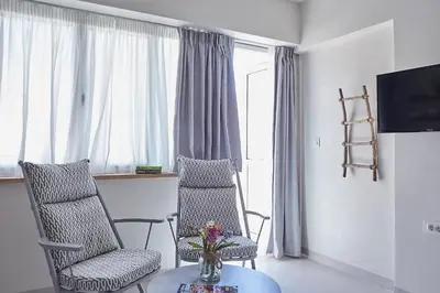a living room with two chairs and a table at toStay-Unique apartment hotel in Athens center! in Athens