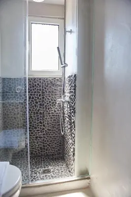 a bathroom with a shower with a glass door at toStay-Unique apartment hotel in Athens center! in Athens
