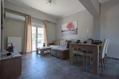 a living room with a table and a couch at Andriana' s apartment Agia Paraskevi in Athens