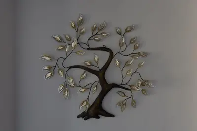 a metal tree with leaves on a white background at Andriana' s apartment Agia Paraskevi in Athens