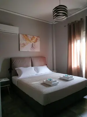 a bedroom with a bed with two towels on it at Andriana' s apartment Agia Paraskevi in Athens