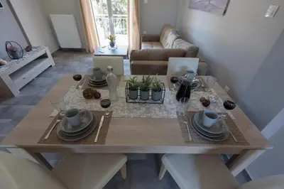 a dining room table with plates and dishes on it at Andriana' s apartment Agia Paraskevi in Athens