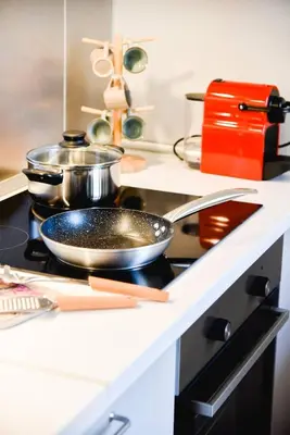 a frying pan on top of a stove in a kitchen at Erst Guest House in Athens