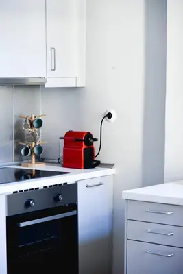 a kitchen with a red appliance sitting on a counter at Erst Guest House in Athens