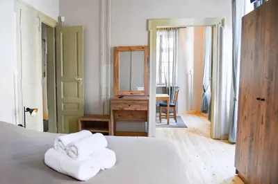 a bedroom with a bed with towels on it at Erst Guest House in Athens