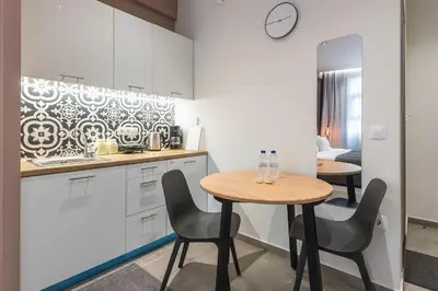 a kitchen with a table and two chairs in a kitchen at Filia Place in Athens