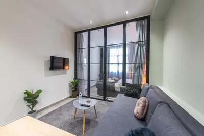 a living room with a couch and a table at Filia Place in Athens