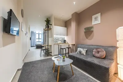 a living room with a couch and a table at Filia Place in Athens