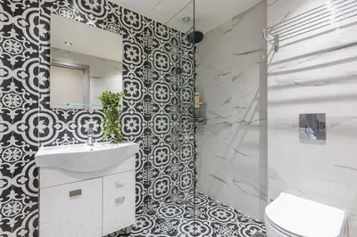 a bathroom with a toilet and a sink and a mirror at Filia Place in Athens