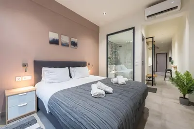 a bedroom with a large bed with towels on it at Filia Place in Athens