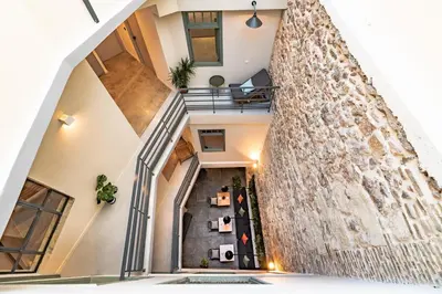 a staircase in a house with a large wall at Athens Hub Hostel in Athens