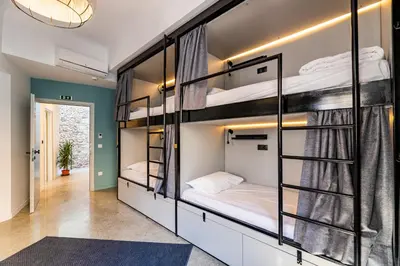 a room with bunk beds and a hallway at Athens Hub Hostel in Athens