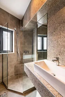 a bathroom with a tub and a glass shower at Athens Hub Hostel in Athens
