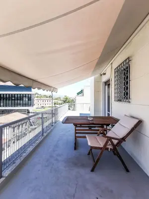 a balcony with a picnic table and a bench at Acropolitana Grand view veranda in Athens