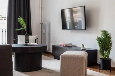 a living room with a table and a mirror at Charming & Comfy 2BD Apartment in Acropolis Area by UPSTREET in Athens