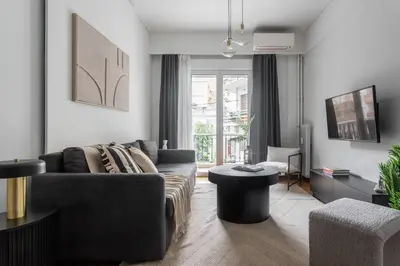 a living room with a couch and a table at Charming & Comfy 2BD Apartment in Acropolis Area by UPSTREET in Athens