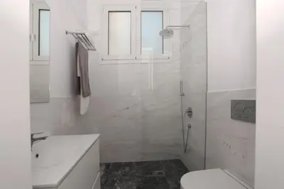 a bathroom with a shower and a toilet and a sink at Plaka Two-Storey Penhouse with Acropolis Views PL6 in Athens