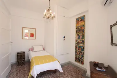 a bedroom with a bed and a chandelier at Plaka Two-Storey Penhouse with Acropolis Views PL6 in Athens