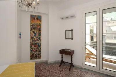 a room with a window and a painting on the wall at Plaka Two-Storey Penhouse with Acropolis Views PL6 in Athens