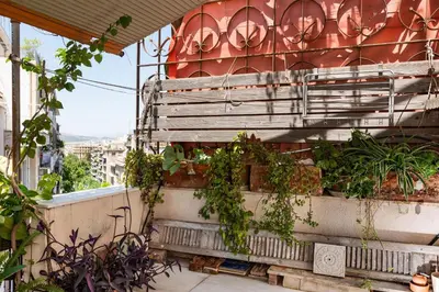 a balcony with plants on the side of a building at Stylish flat with veranda in the heart of Athens in Athens