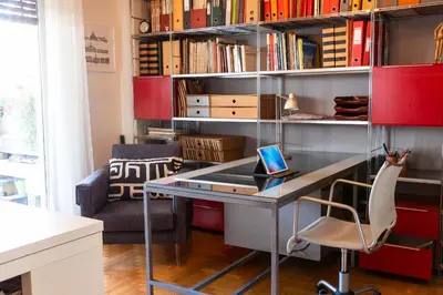 a home office with a desk and bookshelves at Stylish flat with veranda in the heart of Athens in Athens
