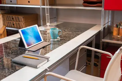 a laptop computer sitting on top of a kitchen counter at Stylish flat with veranda in the heart of Athens in Athens