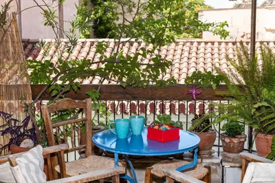 a blue table with a red box on a patio at Stylish flat with veranda in the heart of Athens in Athens