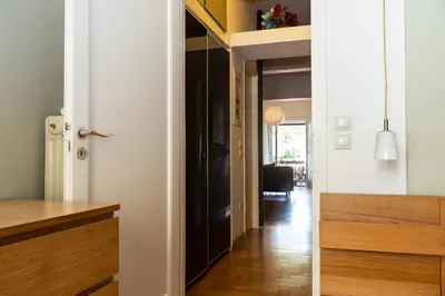 a hallway with a door leading to a living room at Stylish flat with veranda in the heart of Athens in Athens