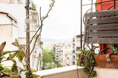 a balcony with plants and a view of a city at Stylish flat with veranda in the heart of Athens in Athens