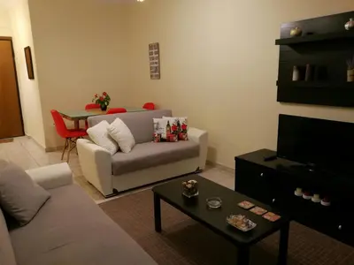 a living room with a couch and a table at Platos Academy Apartment in Athens