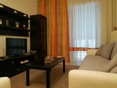 a living room with a couch and a table at Platos Academy Apartment in Athens