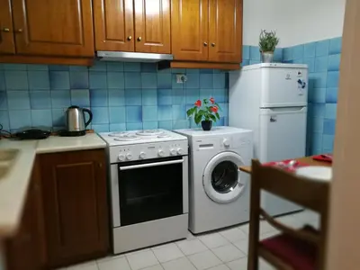 a kitchen with a washing machine and a refrigerator at Platos Academy Apartment in Athens