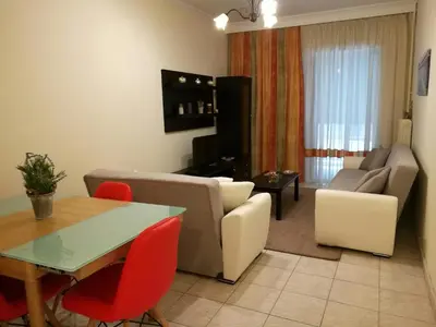 a living room with a couch and a table at Platos Academy Apartment in Athens