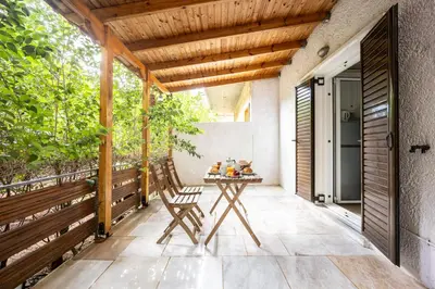 a patio with a table and a wooden ceiling at Cozy Studio in Central Glyfada in Athens