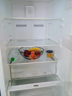 an empty refrigerator with a basket of fruit in it at Uncle Tom's Penthouse in Piraeus