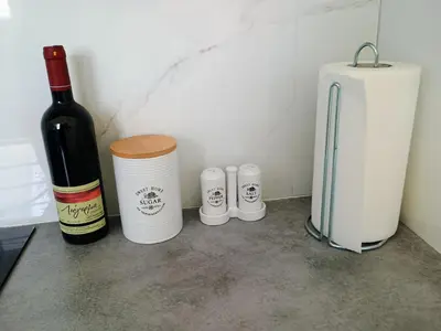a bottle of wine sitting next to a container and a bottle of wine at Uncle Tom's Penthouse in Piraeus