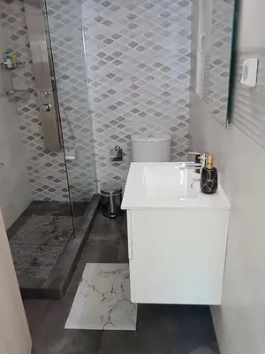 a bathroom with a shower and a white sink at Uncle Tom's Penthouse in Piraeus
