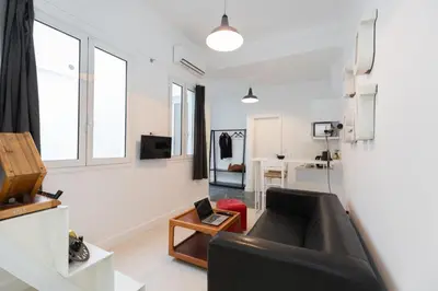 a living room with a couch and a table at Troon of Athens Apartments in Athens